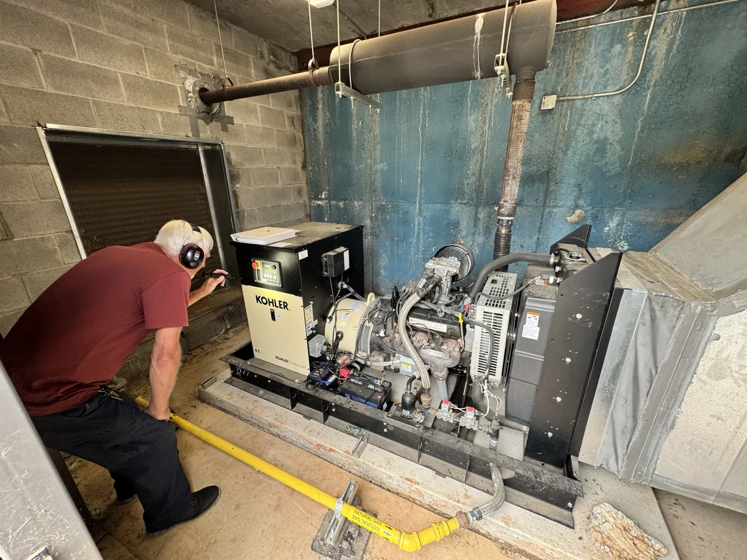 Gen-Up technician servicing a Kohler standby generator at an East Alabama school